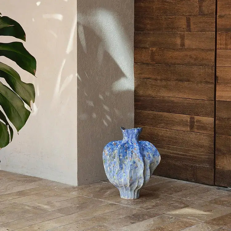 Textured blue irregular porcelain tulip vase with subtle floral patterns for living room decorbites decor