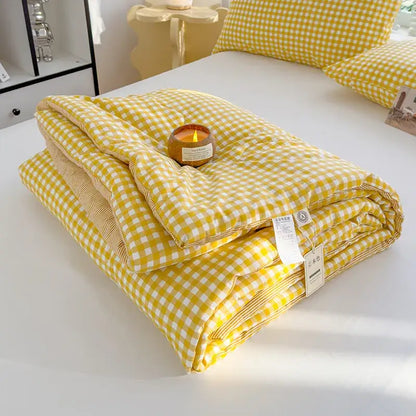 Yellow and white gingham patterned cotton summer quilt with soft plush texture for bedroom comforter use