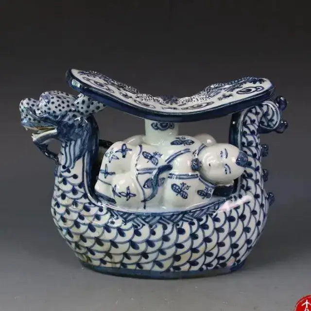 Blue and white porcelain dragon boat statue featuring intricate scales and painted flying insects for bedroom decor