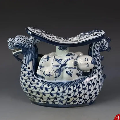 Blue and white porcelain dragon boat statue with intricate patterns for bedroom decor