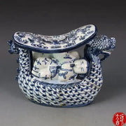 Blue and white porcelain dragon boat statue with detailed scales and painted dragon and children motifs for bedroom decor