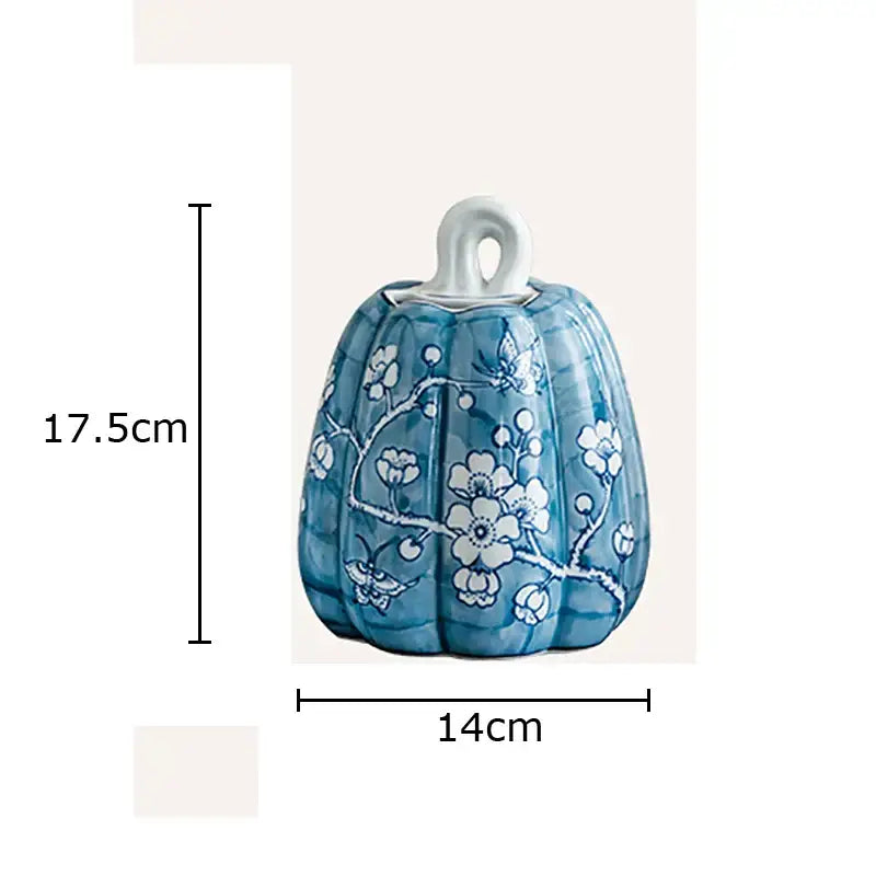 Blue white porcelain pumpkin vase with white floral and butterfly patterns and a looped handle for living room decor