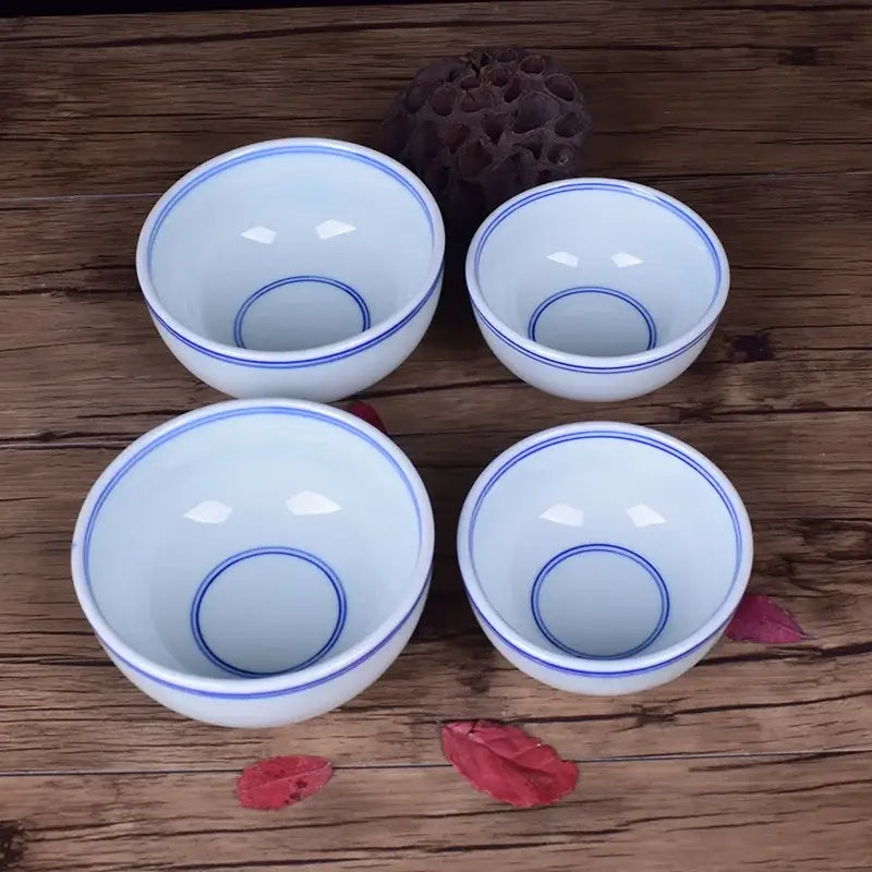 Four white porcelain rice cups with blue circular patterns for dining room ceramic rice bowl set
