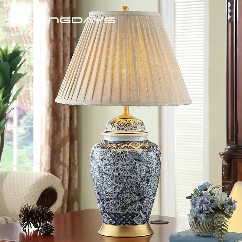 Blue and white porcelain table lamp with gold accents and a beige pleated fabric shade for living room decorbites blue porcelain