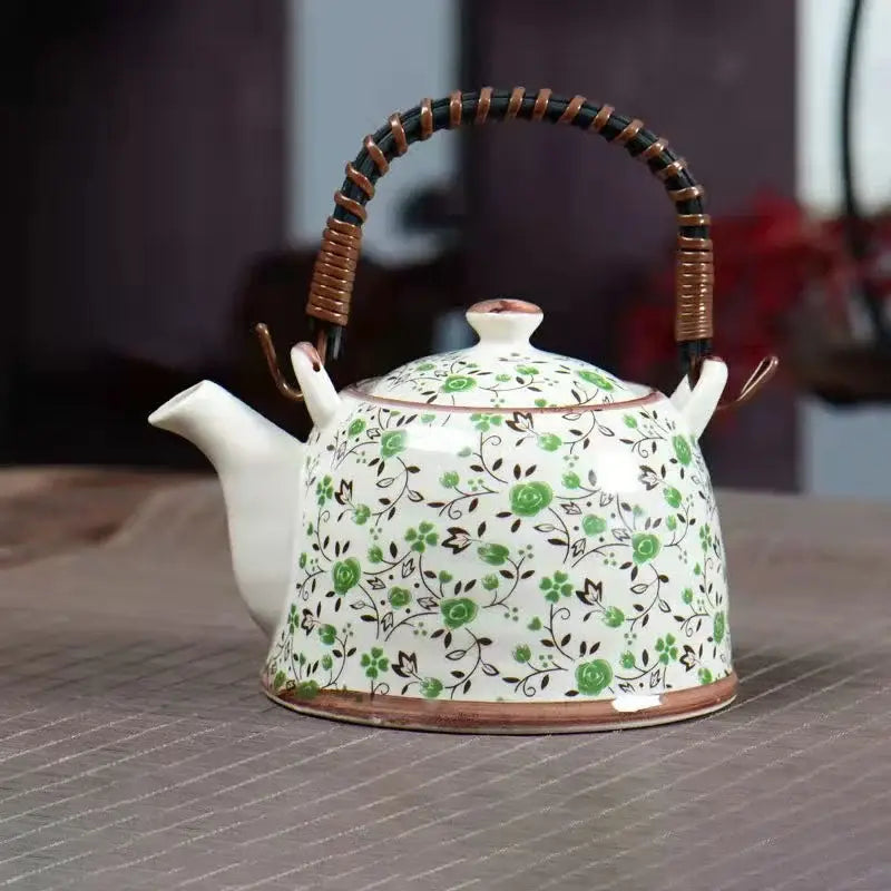 White porcelain teapot with green floral pattern and brown woven handle from decorbites blue dining room set