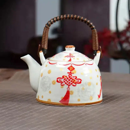 White porcelain teapot with red and gold Chinese knot design and bamboo handle from decorbites blue set