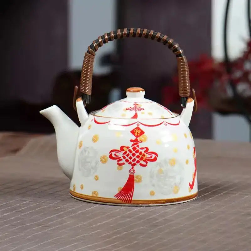 White porcelain teapot with red and gold Chinese knot design and bamboo handle from decorbites blue set