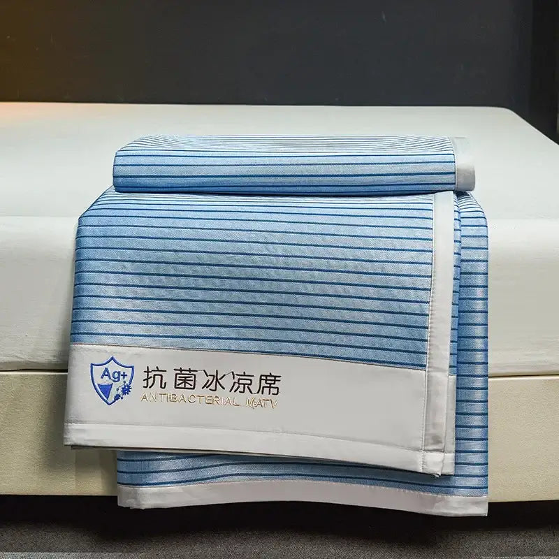 Blue and white striped antibacterial cooling bed mat with stitched border from decorbites cooling bed mat set