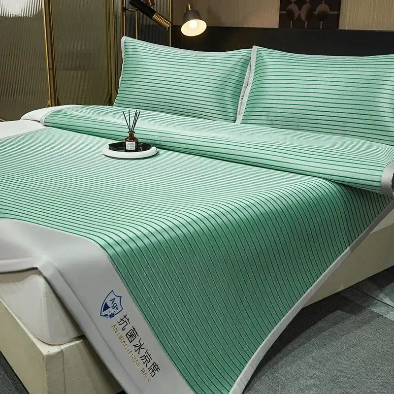 Green striped decorbites cooling bed mat with white trim and branded logo in a blue and white striped mat set