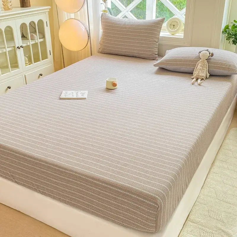 Beige striped fitted sheet set with subtle vertical lines and soft textured fabric for bedroom use