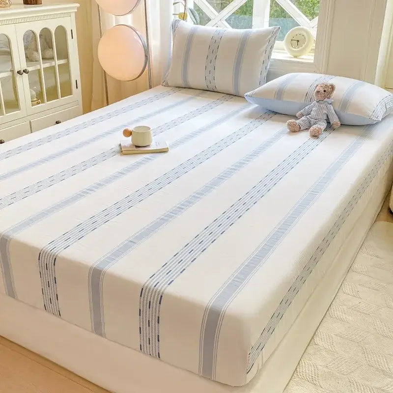 A blue and white striped cotton jacquard fitted sheet set with elegant light blue stripes and dotted edge detailing