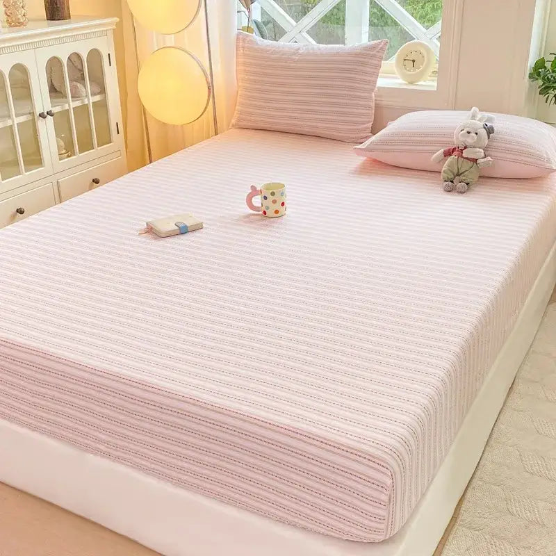 Blue and white striped cotton jacquard fitted sheet set featuring a pink striped ribbed textured fitted sheet
