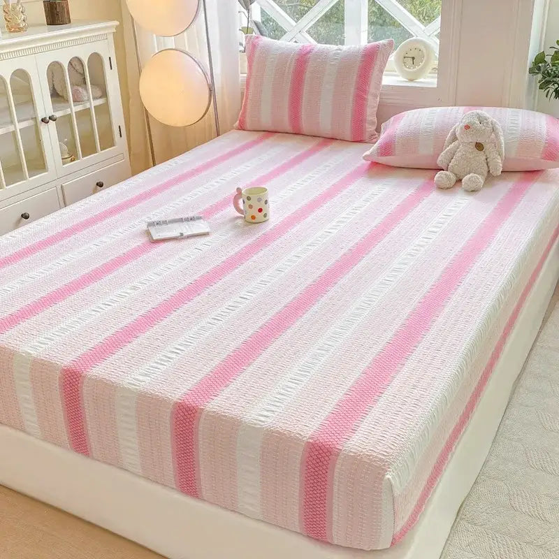 Pink and white striped fitted sheet with textured woven fabric finish for cotton jacquard sheet set bedroom use