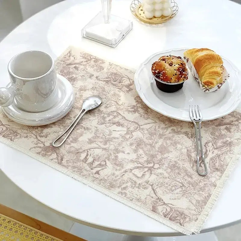 Beige cotton linen place mat with frayed edges and delicate brown vintage animal and tree pattern from decorbites cotton linen set