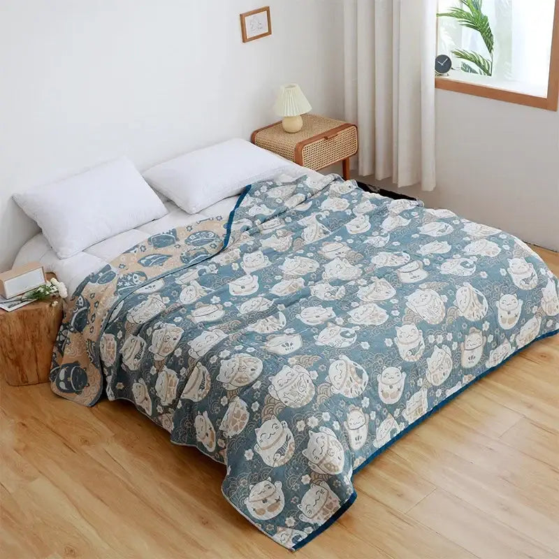 A soft teal cotton cartoon cat summer quilt blanket with cream lucky cat pattern and floral accents for bedroom decor