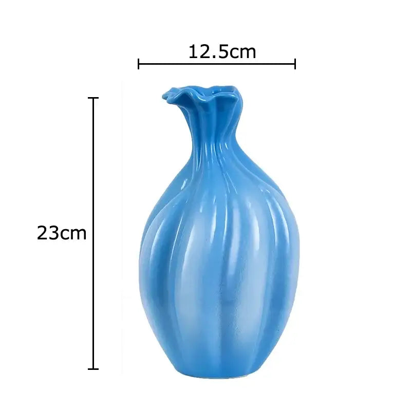 Glossy light blue ceramic flower bud vase with fluted ribbed body and ruffled neck for decorbites blue ceramic decor