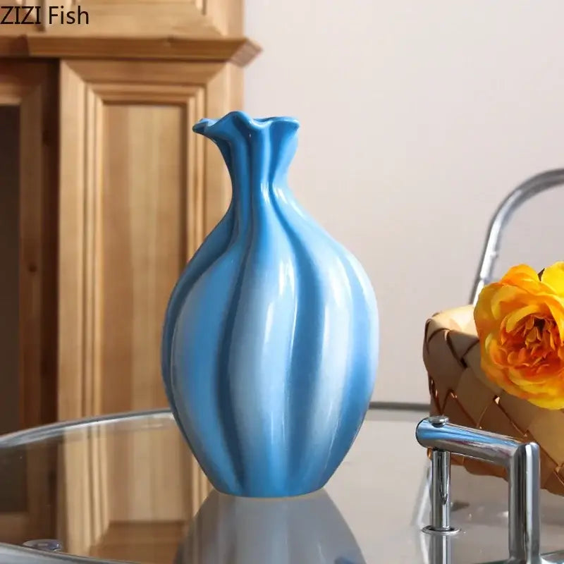 A sleek glossy blue ceramic flower bud vase with a fluted neck and ribbed body for decorbites blue ceramic decor