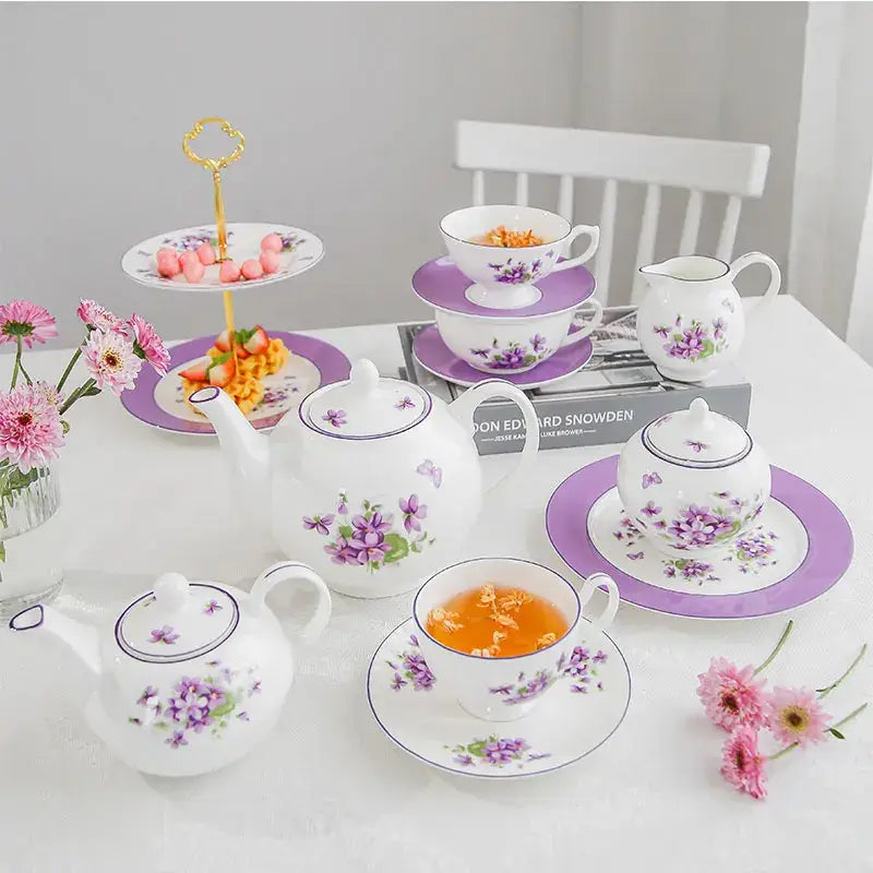 White porcelain teapot with purple floral patterns and curved handles from the blue dream tea set for elegant dining