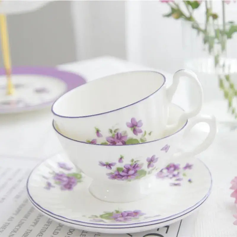 White porcelain tea set with delicate purple floral patterns and blue rim from blue dream tea collection