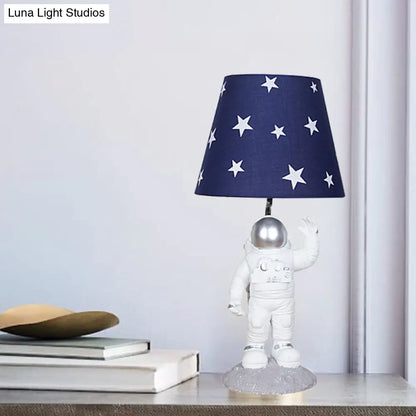 Blue Empire Shade Night Lamp - Kids Star Patterned Fabric Table Lighting with Carved Spaceman Base, 10"/13" Wide