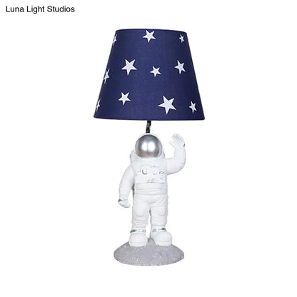 Blue Empire Shade Night Lamp - Kids Star Patterned Fabric Table Lighting with Carved Spaceman Base, 10"/13" Wide