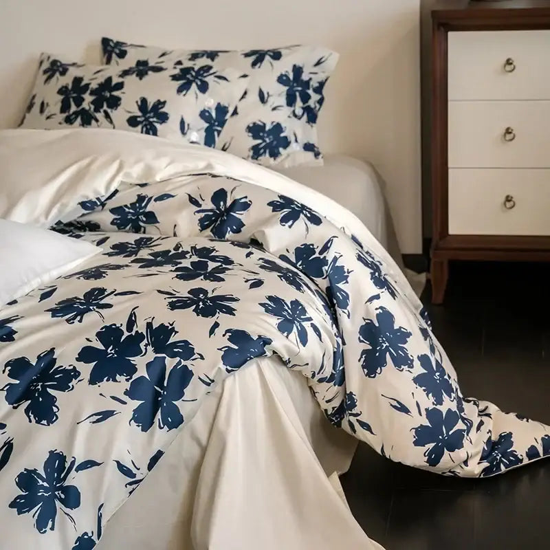 Cream-colored duvet cover with bold navy blue floral pattern in decorbites 100s egyptian cotton bedding set