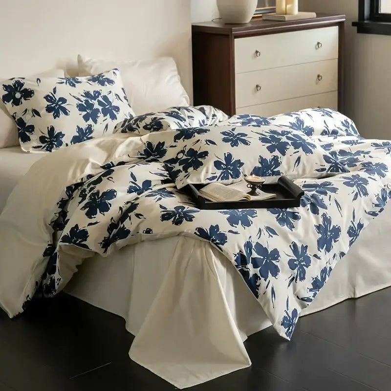 Cream-colored duvet bedding set with bold navy blue floral patterns made from decorbites 100s egyptian cotton