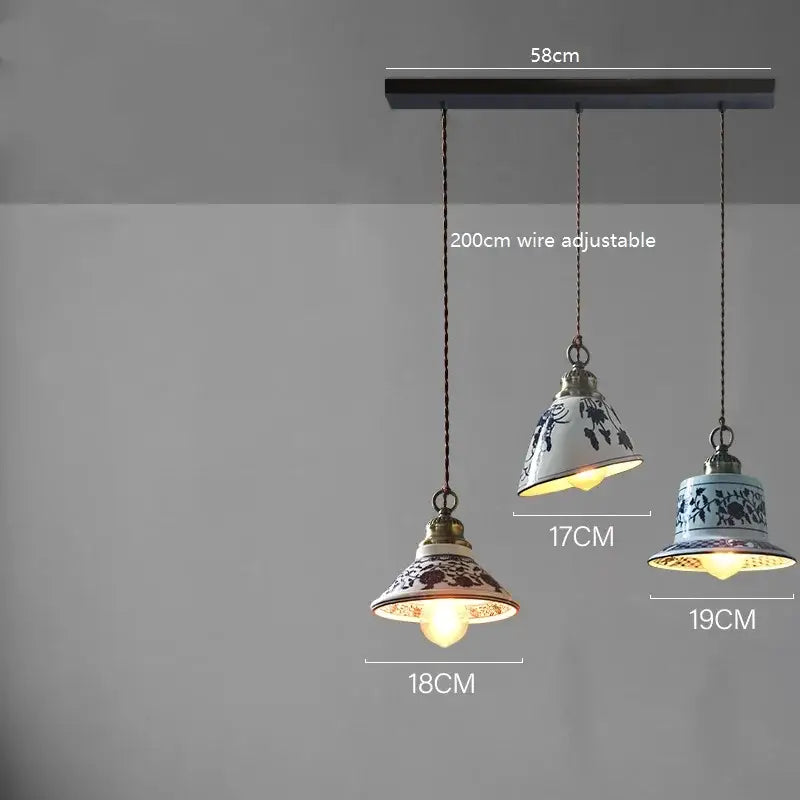 Set of three blue floral ceramic led pendant lamps with brass accents and adjustable wires for dining room lighting decorbites ceramic led