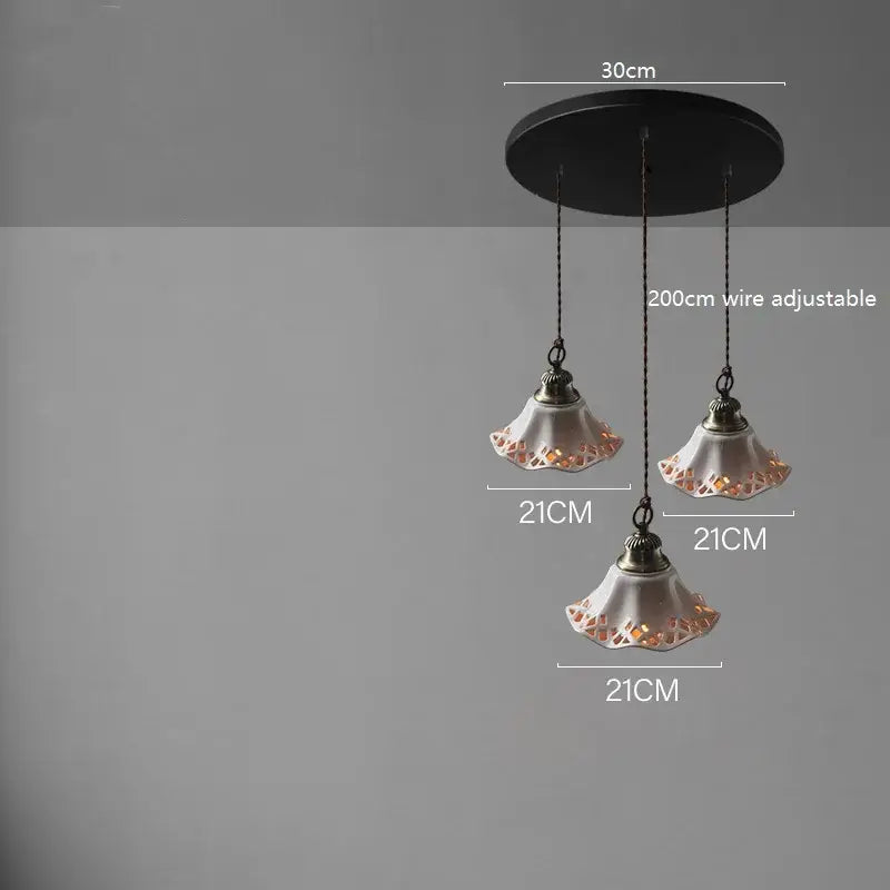 Blue floral ceramic led pendant lamp with cream lace-cut ceramic shades and dark metal hardware for dining room lighting