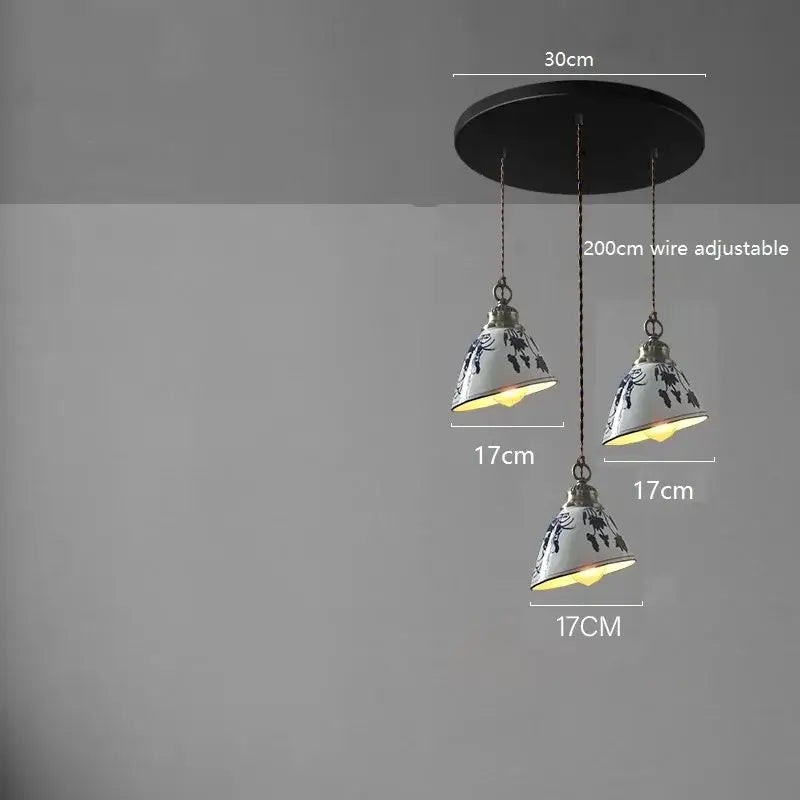 Three blue floral ceramic led pendant lamps hanging from a black mount for dining room lighting by decorbites ceramic led