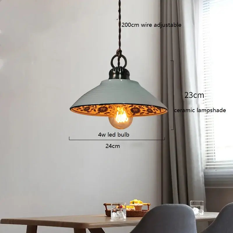 Blue floral ceramic led pendant lamp with matte light blue shade and ornate gold interior pattern by decorbites