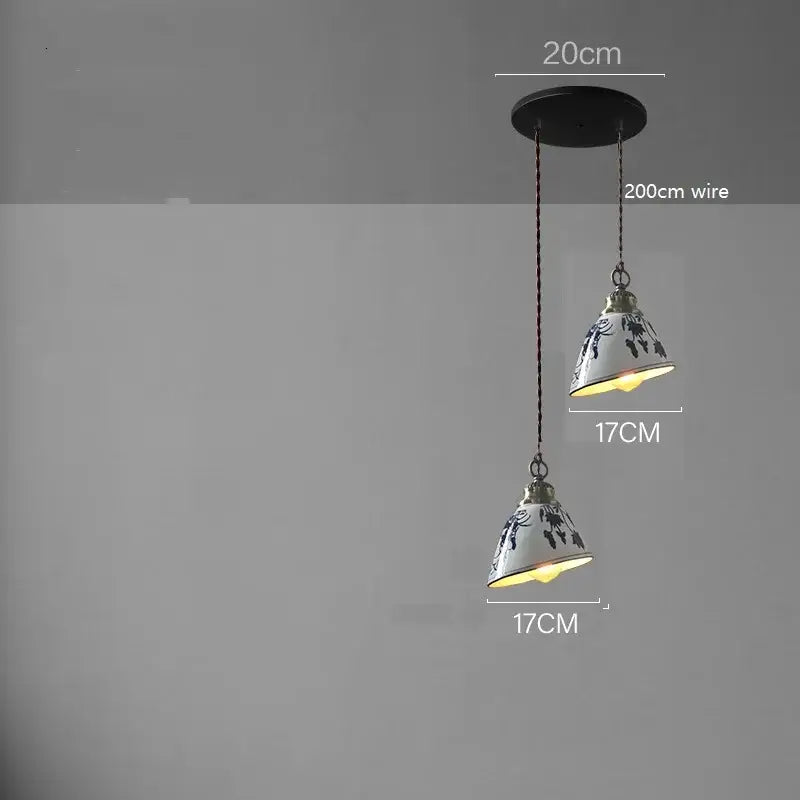 White ceramic led pendant lamp with black floral patterns and brass accents suspended by 200cm wire for dining decorbites ceramic led