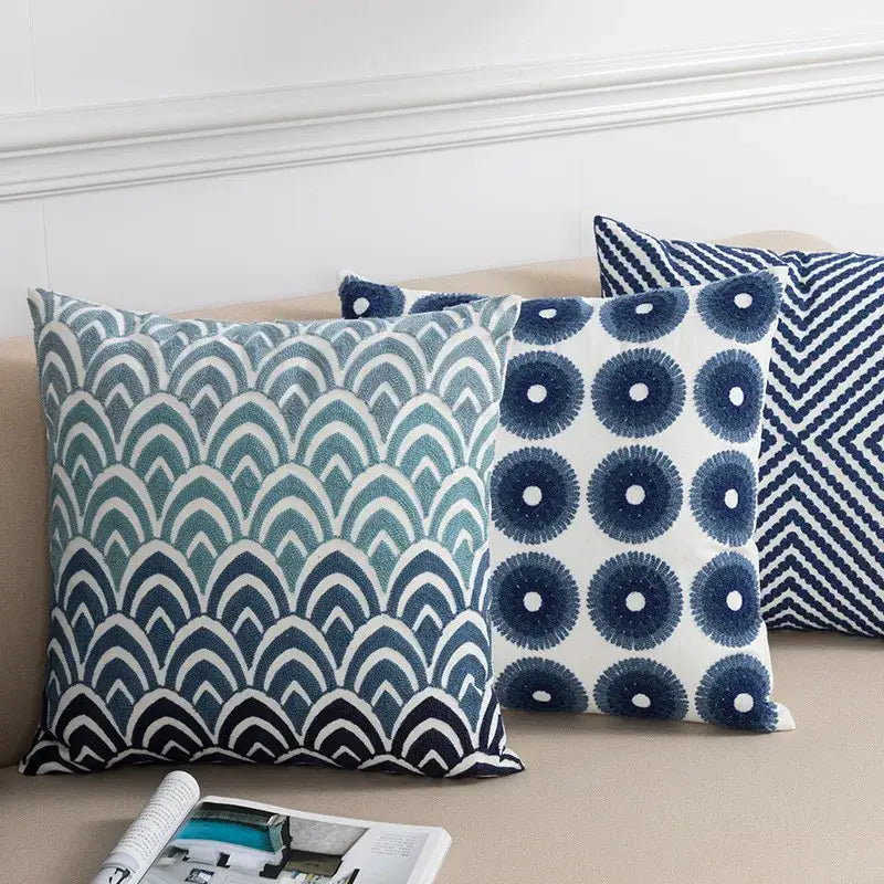 Three decorative throw pillows with blue floral geometric cushion cover featuring embroidered scalloped waves and zigzag decorbites design
