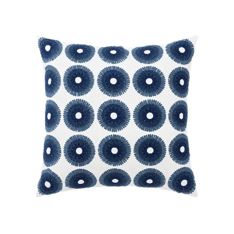 White throw pillow with navy blue embroidered circular patterns in a decorbites blue floral geometric cushion cover set