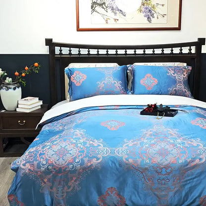 Blue floral satin jacquard duvet cover set in blue satin with intricate pink and white ornamental patterns by decorbites