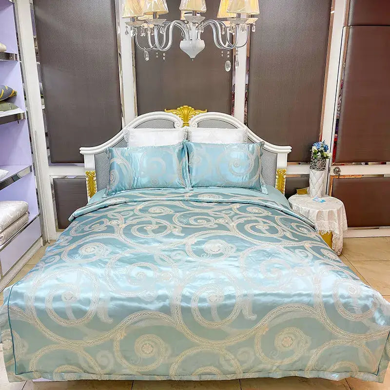 Blue satin jacquard duvet cover set featuring light blue satin with intricate white and gold swirling patterns