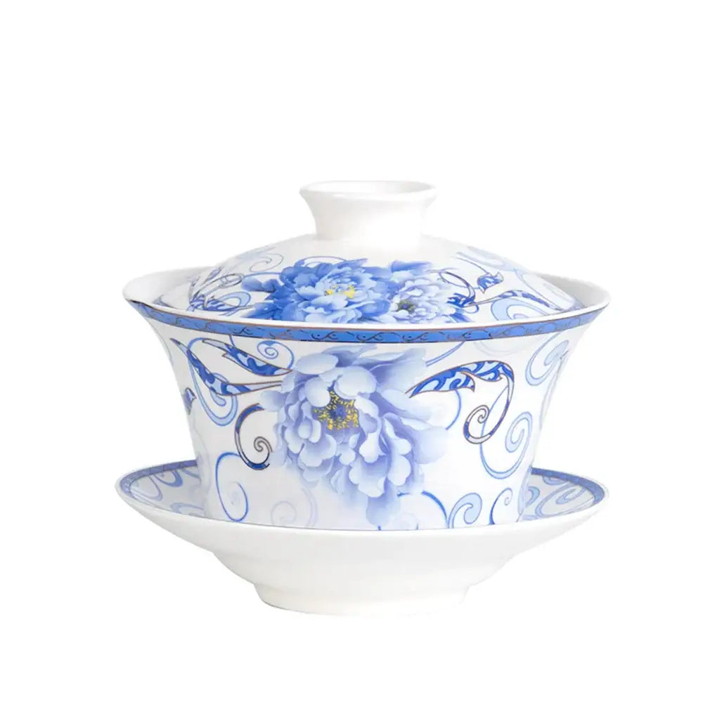 A white porcelain tea cup set featuring a teapot with intricate blue floral peony patterns for dining room use