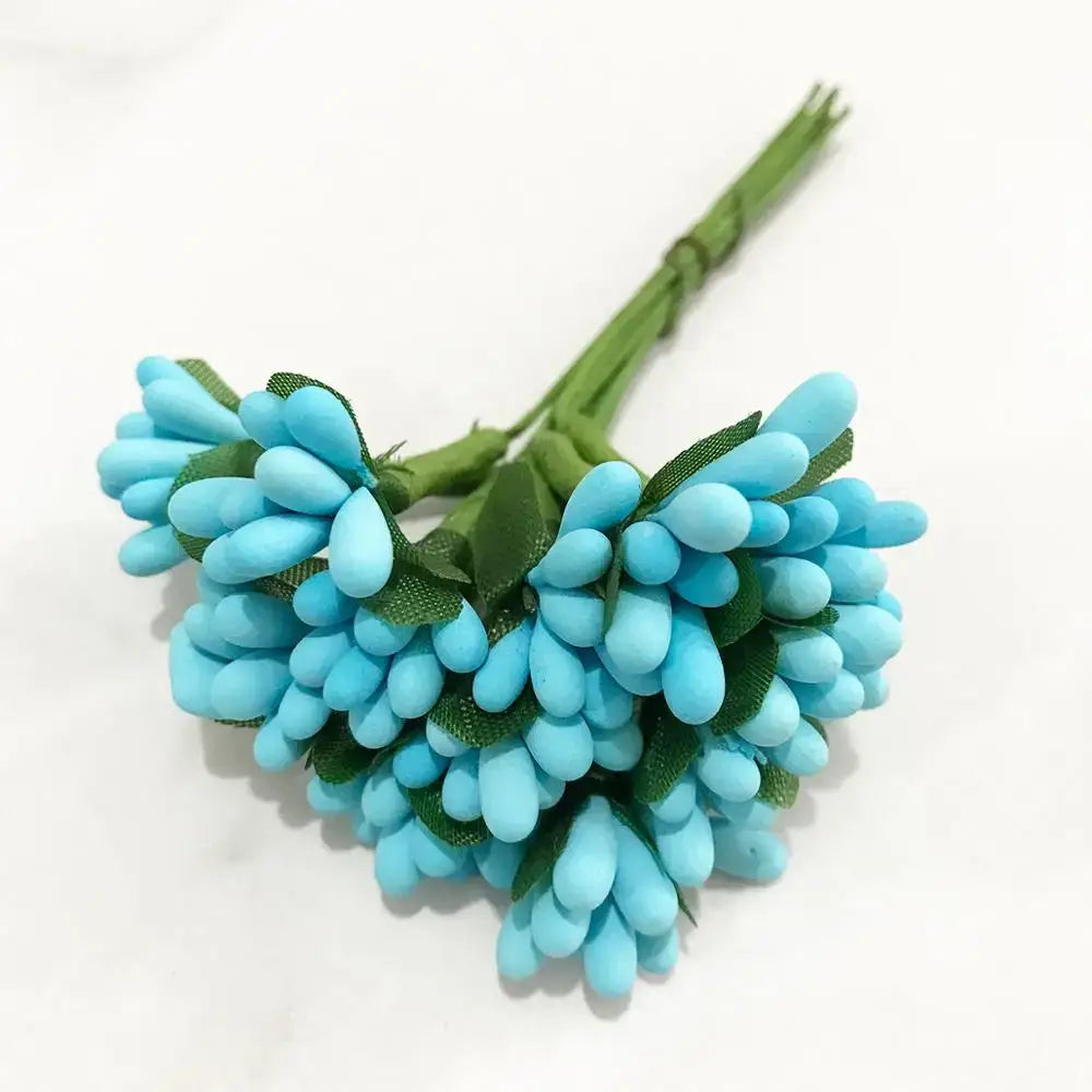 A cluster of artificial turquoise decorbites blue flower cherry stamen berries with green fabric leaves for living room decor