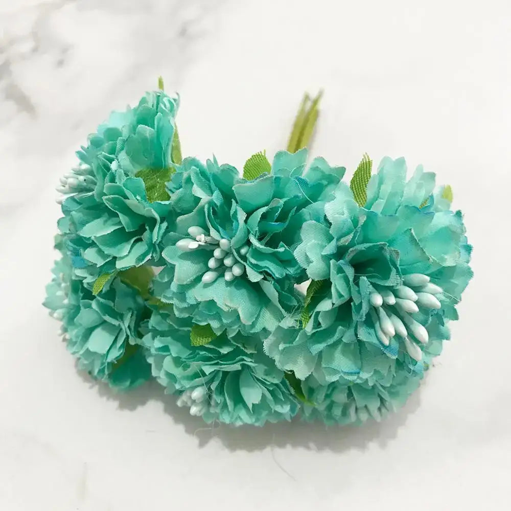 A cluster of teal artificial fabric decorbites blue flower cherry stamen berries with green stems for living room decor