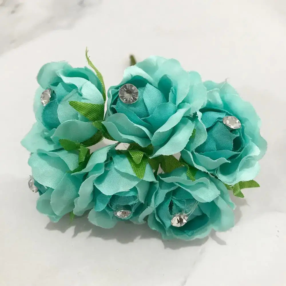 A cluster of turquoise decorbites blue flower cherry fabric roses with clear rhinestones and green leaves for living room decor