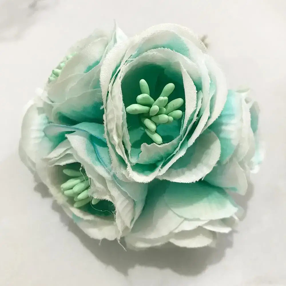 A delicate mint and white decorbites blue flower cherry with layered fabric petals and green center for living room decor
