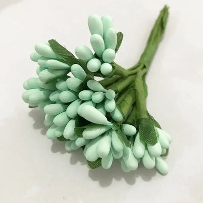 A delicate cluster of mint-green decorbites blue flower cherry artificial flowers with flower cherry stamen wrapped in green mesh