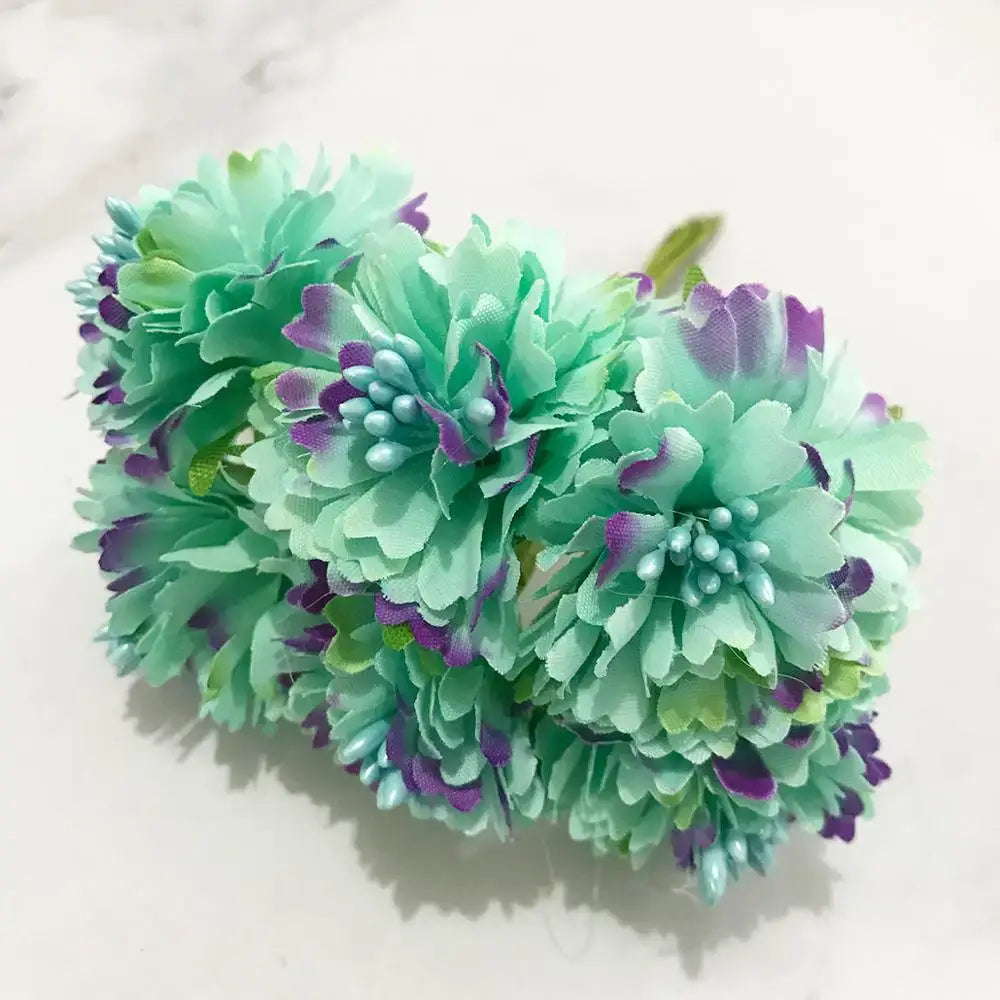 A bundle of decorbites blue flower cherry stamen artificial flowers with mint green petals edged in purple and light blue beads