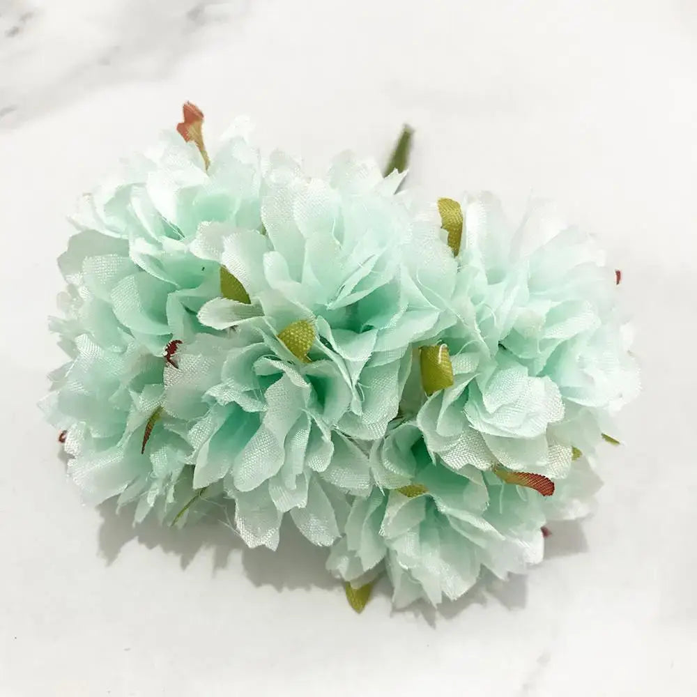 A delicate cluster of mint-green fabric blue flower cherry with subtle texture and tiny green stamen berries for decorbites decor