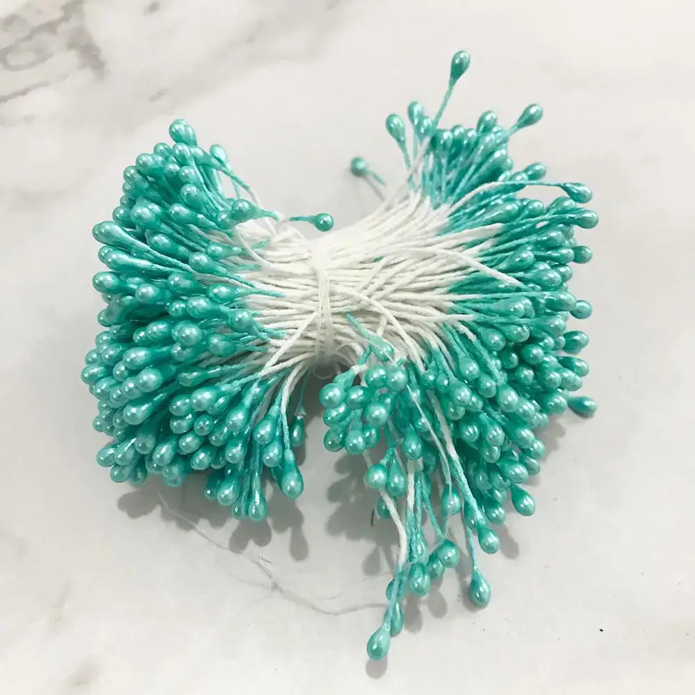 A bundle of teal blue flower cherry stamen berries with glossy stems tied together for living room decorbites decor