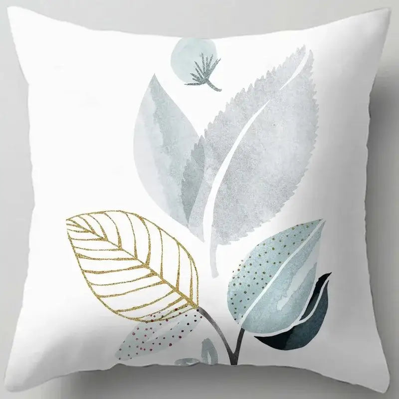 White throw pillow with decorbites blue flower leaves pattern in soft gray teal and gold accents for living room decor