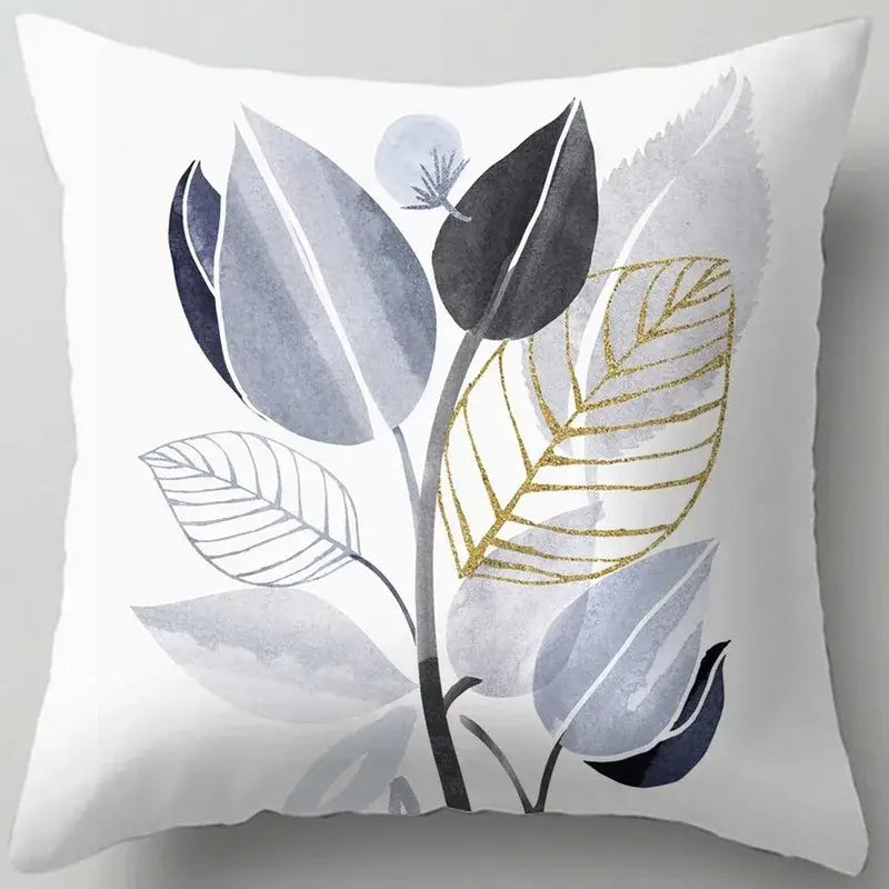 White throw pillow with a blue flower leaves pattern featuring modern watercolor gray black and gold decorbites blue flower design
