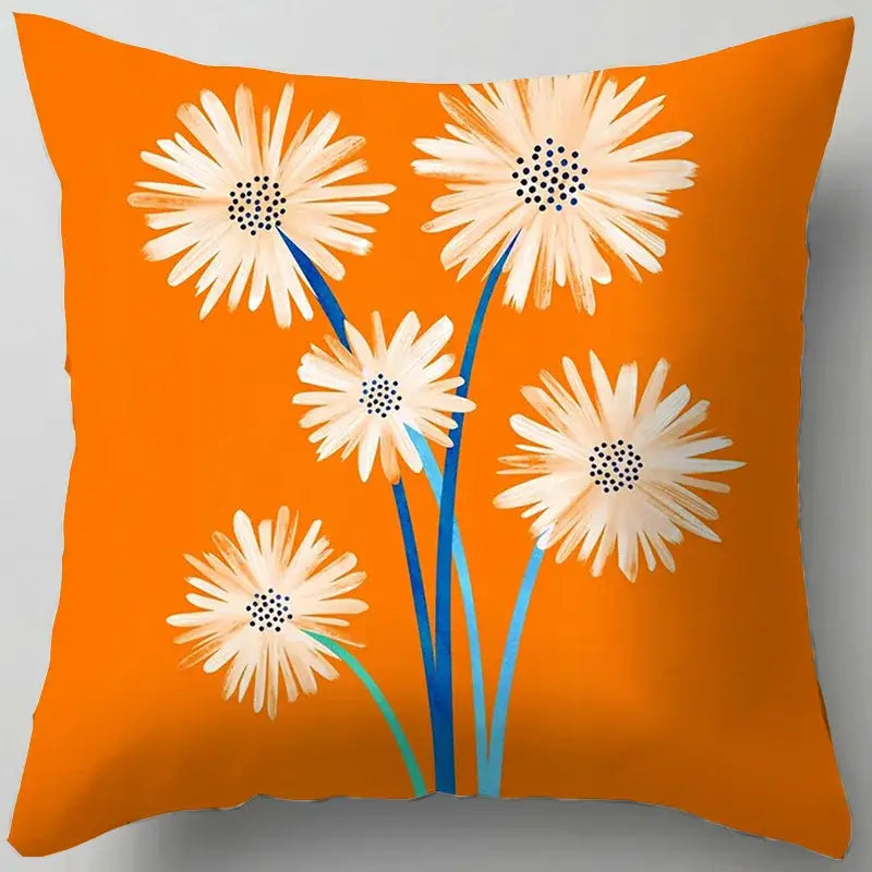 Vibrant orange throw pillow with blue flower leaves pattern featuring stylized cream daisies for decorbites blue flower decor