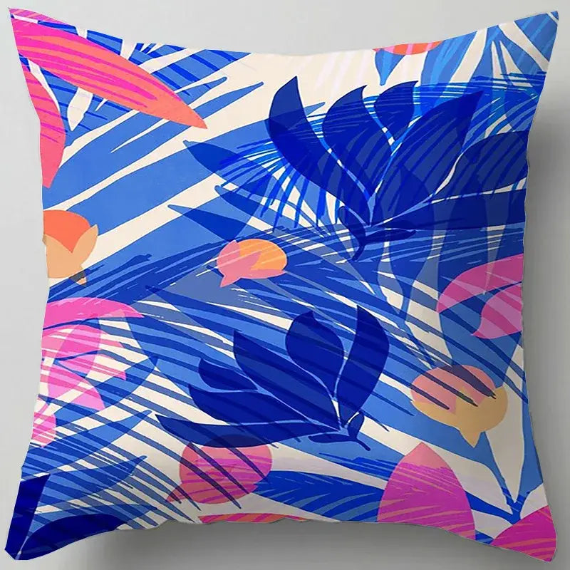 Vibrant tropical-themed square pillow with bold blue flower leaves pattern on white background for living room decorbites decor