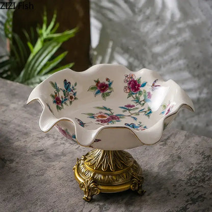 A white ceramic blue flower pattern footed fruit bowl with gold trim on an ornate golden base for decorbites blue flower decor